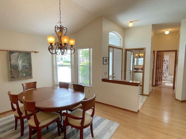 508 Alcazar Ct, Lady Lake, FL 32159 - dining space featuring a chandelier, light wood finished floors, and a textured ceiling