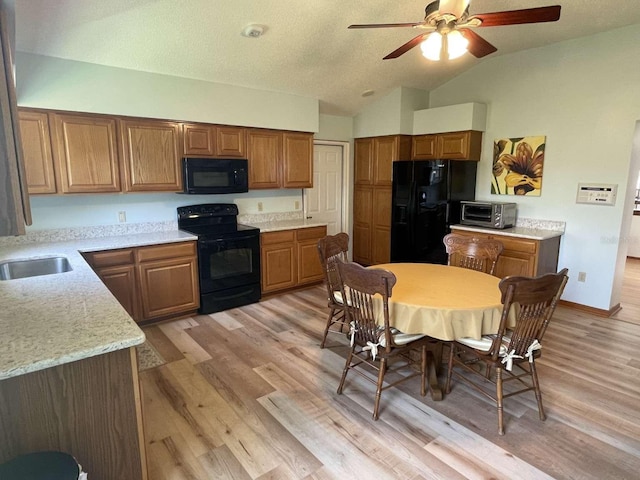 508 Alcazar Ct, Lady Lake, FL 32159 - kitchen featuring black appliances, brown cabinets, vaulted ceiling, a ceiling fan, and light wood-style flooring