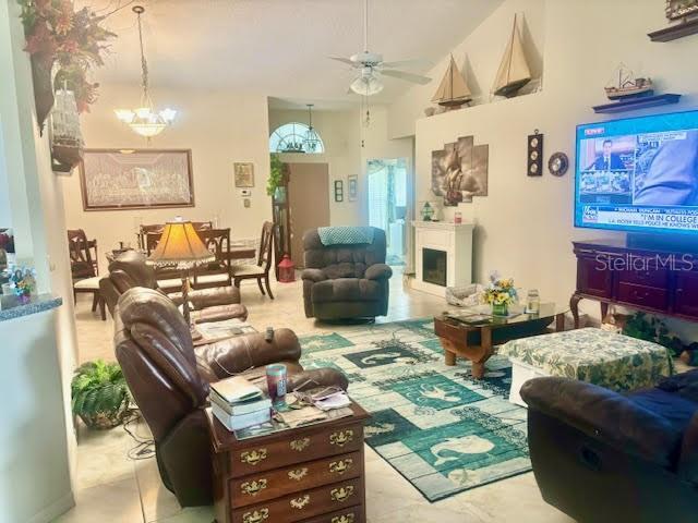 1607 Alexander Crossing Way, Sun City Center, FL 33573 - living room featuring ceiling fan and a chandelier