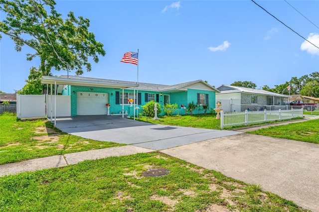5107 Pine St, Seffner, FL 33584 - single story home with concrete driveway, an attached garage, and a carport