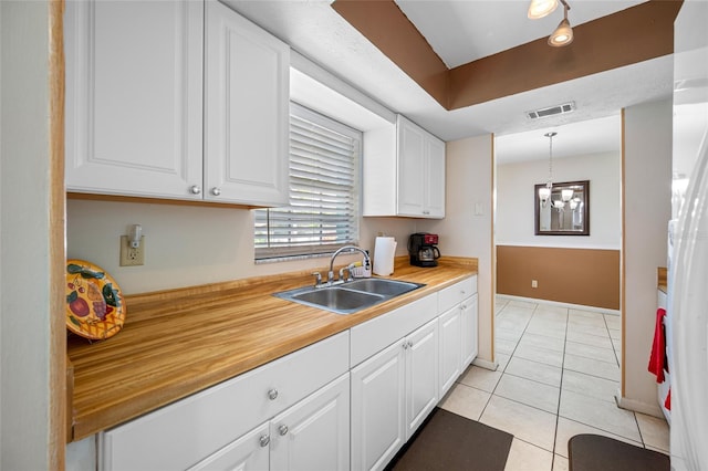 5107 Pine St, Seffner, FL 33584 - kitchen with white cabinetry, light tile patterned floors, and light countertops
