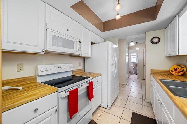 5107 Pine St, Seffner, FL 33584 - kitchen featuring white appliances, light tile patterned flooring, and white cabinetry