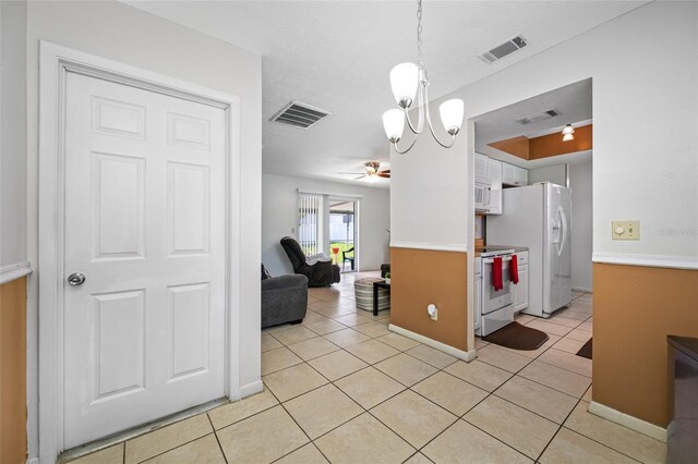 5107 Pine St, Seffner, FL 33584 - kitchen featuring white appliances, light tile patterned floors, a chandelier, and a ceiling fan