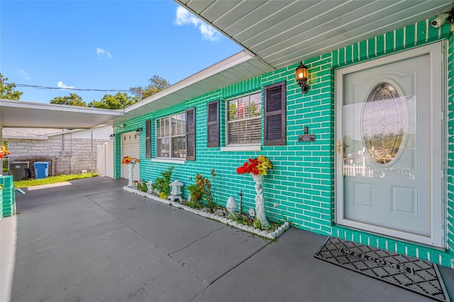 5107 Pine St, Seffner, FL 33584 - view of exterior entry with brick siding, a garage, and a security system