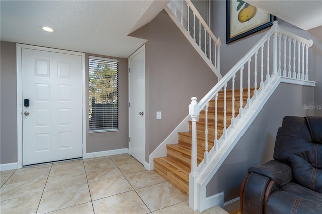 5340 Cobblestone Ct, Wesley Chapel, FL 33543 - foyer entrance featuring stairway, a textured ceiling, tile patterned floors, and recessed lighting
