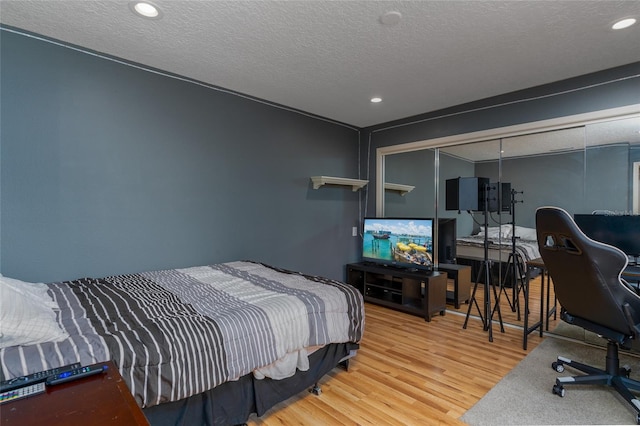 5340 Cobblestone Ct, Wesley Chapel, FL 33543 - bedroom with wood finished floors, a textured ceiling, recessed lighting, and a desk