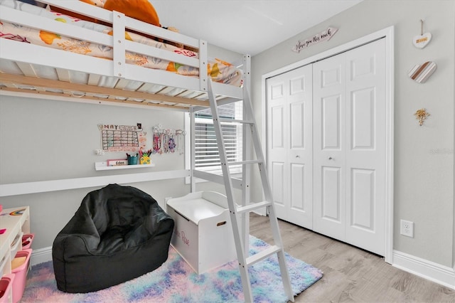 12382 Tibbetts St, Odessa, FL 33556 - bedroom featuring wood finished floors and a closet