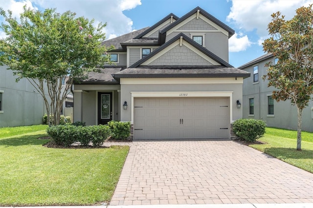 12382 Tibbetts St, Odessa, FL 33556 - view of front of property featuring decorative driveway, a front lawn, a shingled roof, and stucco siding
