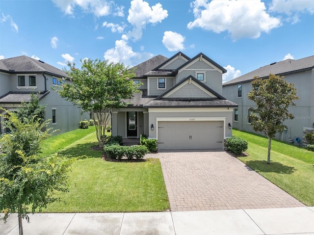 12382 Tibbetts St, Odessa, FL 33556 - craftsman inspired home featuring decorative driveway, a garage, a front lawn, and a shingled roof