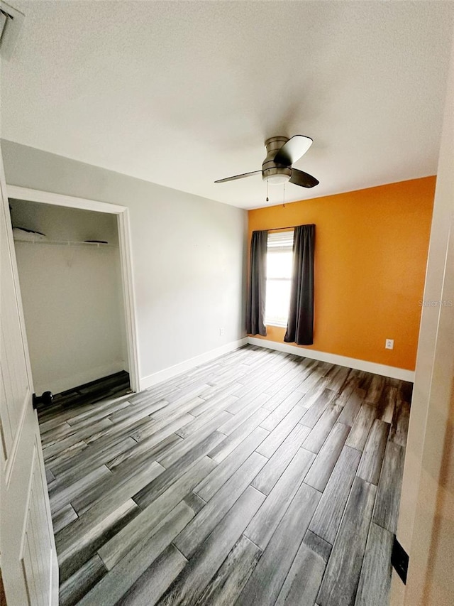 19743 Ellendale Dr, Land O Lakes, FL 34638 - empty room with wood finished floors and ceiling fan