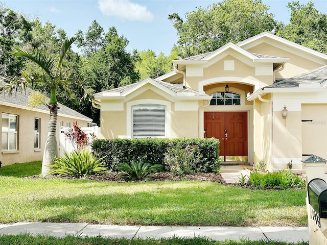 19743 Ellendale Dr, Land O Lakes, FL 34638 - view of front of house featuring stucco siding, a front yard, and a garage