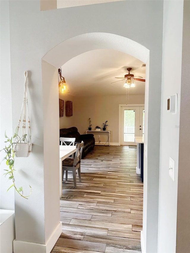 19743 Ellendale Dr, Land O Lakes, FL 34638 - hallway featuring arched walkways and light wood finished floors