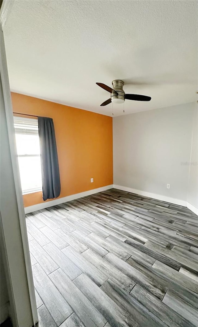 19743 Ellendale Dr, Land O Lakes, FL 34638 - unfurnished room featuring a textured ceiling, a ceiling fan, and wood finished floors