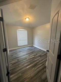 19743 Ellendale Dr, Land O Lakes, FL 34638 - unfurnished room featuring baseboards and wood finished floors