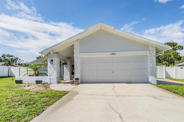 1304 Cedar Ct, Tarpon Springs, FL 34689 - view of front facade featuring stone siding and concrete driveway
