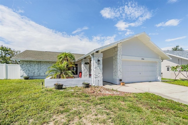 1304 Cedar Ct, Tarpon Springs, FL 34689 - single story home with stone siding, a garage, and driveway
