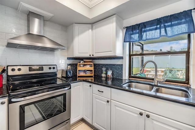 1304 Cedar Ct, Tarpon Springs, FL 34689 - kitchen featuring wall chimney exhaust hood, electric stove, white cabinets, backsplash, and ornamental molding