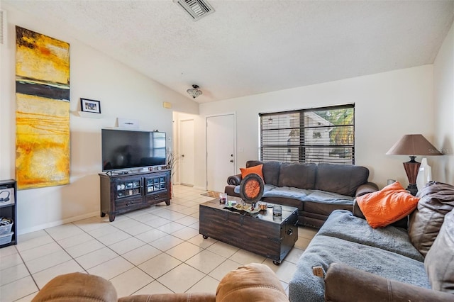 1304 Cedar Ct, Tarpon Springs, FL 34689 - living area with vaulted ceiling, light tile patterned flooring, and a textured ceiling
