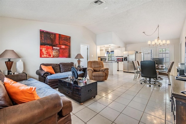 1304 Cedar Ct, Tarpon Springs, FL 34689 - living area with lofted ceiling, light tile patterned floors, a chandelier, and a textured ceiling