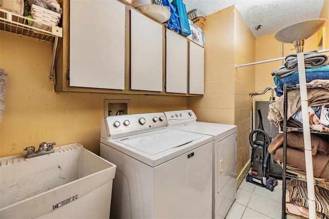1304 Cedar Ct, Tarpon Springs, FL 34689 - laundry room featuring cabinet space, washer and dryer, and light tile patterned flooring