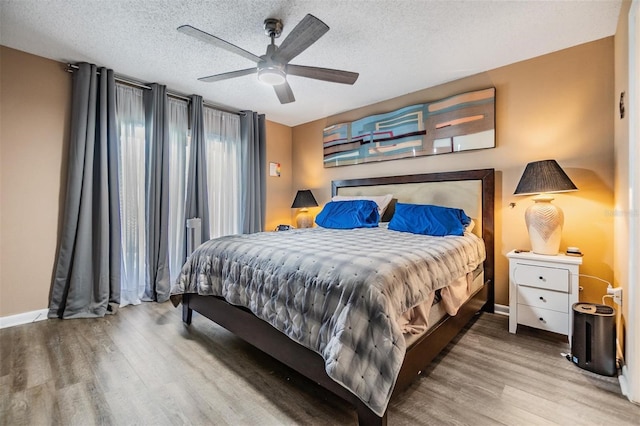 1304 Cedar Ct, Tarpon Springs, FL 34689 - bedroom with wood finished floors, a textured ceiling, and a ceiling fan