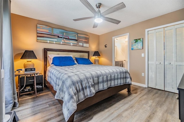 1304 Cedar Ct, Tarpon Springs, FL 34689 - bedroom featuring wood finished floors, a closet, ensuite bath, and a ceiling fan