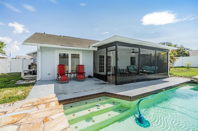 1304 Cedar Ct, Tarpon Springs, FL 34689 - rear view of property with french doors, a patio area, a fenced backyard, a sunroom, and stucco siding