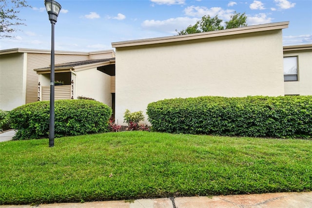 4114 Pinelake Ln Unit 202, Tampa, FL 33618 - view of home's exterior featuring stucco siding and a yard