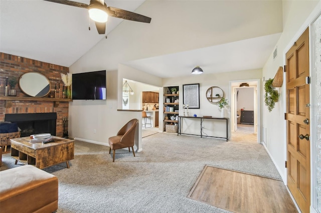 4114 Pinelake Ln Unit 202, Tampa, FL 33618 - carpeted living room with a fireplace, vaulted ceiling, and a ceiling fan