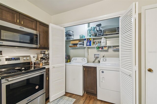 4114 Pinelake Ln Unit 202, Tampa, FL 33618 - laundry room featuring independent washer and dryer and light wood-style floors
