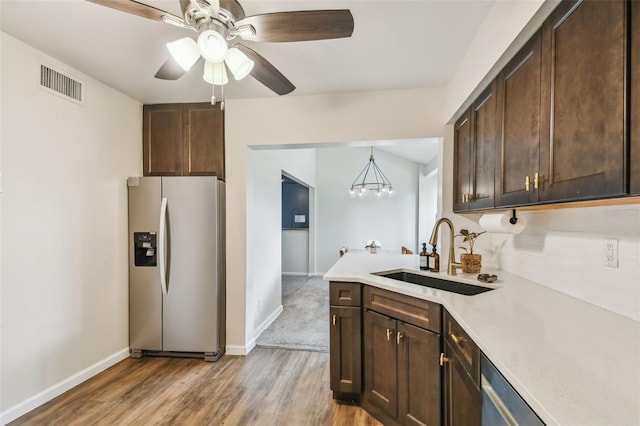 4114 Pinelake Ln Unit 202, Tampa, FL 33618 - kitchen featuring stainless steel fridge with ice dispenser, dark brown cabinetry, light countertops, light wood finished floors, and decorative backsplash