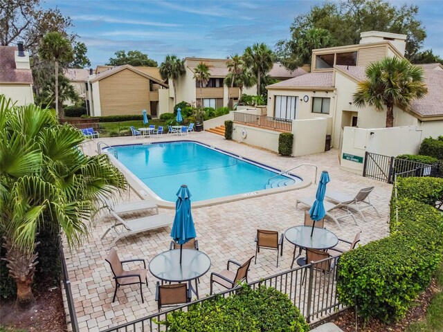 4114 Pinelake Ln Unit 202, Tampa, FL 33618 - community pool with a patio area and a residential view