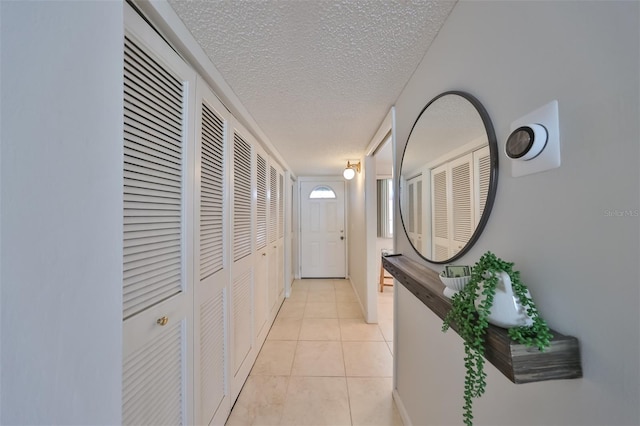1591 Gulf Blvd Unit 304S, Clearwater Beach, FL 33767 - corridor featuring a textured ceiling and light tile patterned floors
