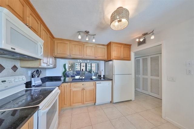 1591 Gulf Blvd Unit 304S, Clearwater Beach, FL 33767 - kitchen with white appliances, backsplash, a chandelier, and light tile patterned floors
