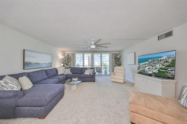 1591 Gulf Blvd Unit 304S, Clearwater Beach, FL 33767 - living area featuring a ceiling fan, a textured ceiling, and carpet