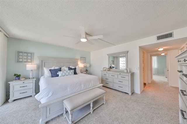 1591 Gulf Blvd Unit 304S, Clearwater Beach, FL 33767 - bedroom with a textured ceiling, light carpet, and a ceiling fan