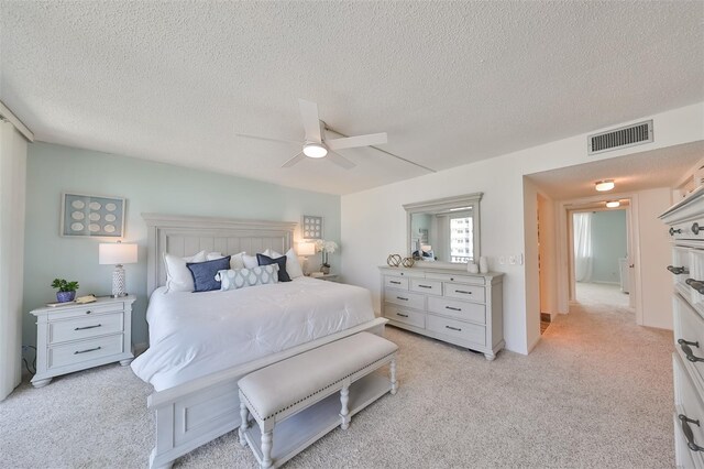 1591 Gulf Blvd Unit 304S, Clearwater Beach, FL 33767 - bedroom featuring a textured ceiling, light colored carpet, and a ceiling fan