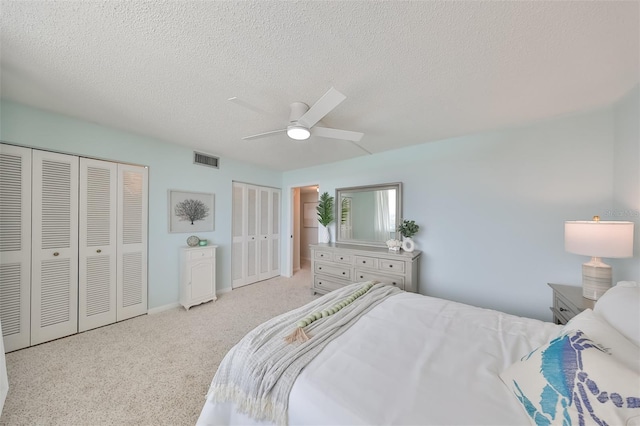 1591 Gulf Blvd Unit 304S, Clearwater Beach, FL 33767 - bedroom with two closets, a textured ceiling, carpet floors, and a ceiling fan