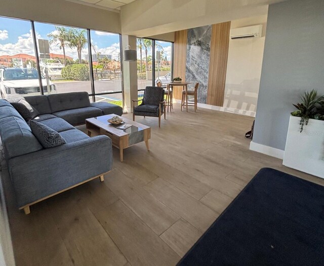 1591 Gulf Blvd Unit 304S, Clearwater Beach, FL 33767 - living room featuring a wall mounted AC and wood finished floors