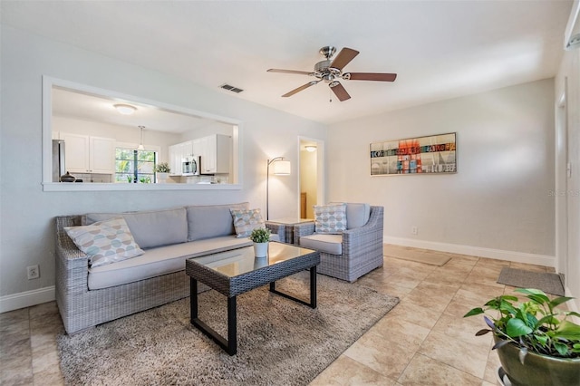 201 W Alva St, Tampa, FL 33603 - living room with a ceiling fan and baseboards
