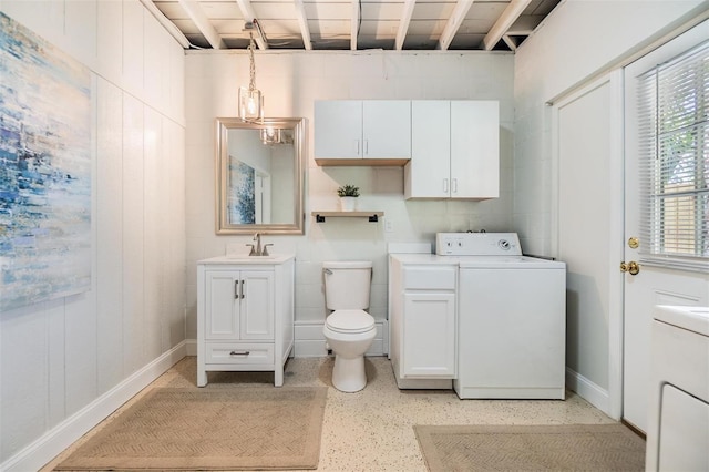 201 W Alva St, Tampa, FL 33603 - bathroom with washer / dryer, vanity, and speckled floor