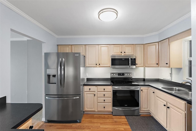700 Beach Dr NE Unit 606, Saint Petersburg, FL 33701 - kitchen with appliances with stainless steel finishes, light wood-type flooring, dark countertops, crown molding, and cream cabinets