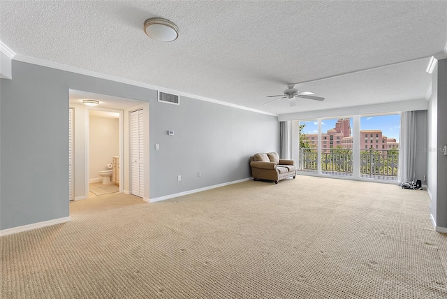 700 Beach Dr NE Unit 606, Saint Petersburg, FL 33701 - unfurnished room featuring light colored carpet, a ceiling fan, crown molding, and a textured ceiling