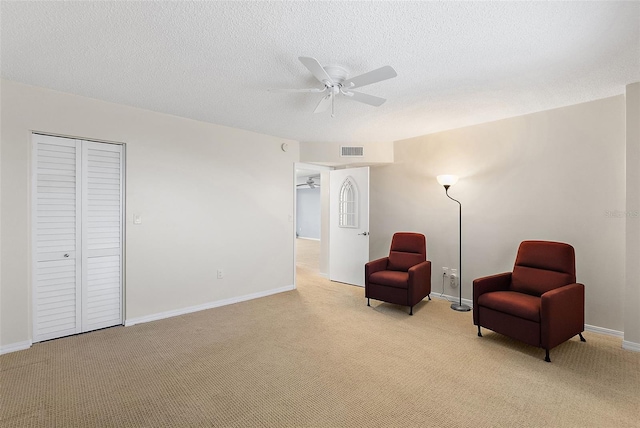 700 Beach Dr NE Unit 606, Saint Petersburg, FL 33701 - living area with a ceiling fan, light carpet, and a textured ceiling