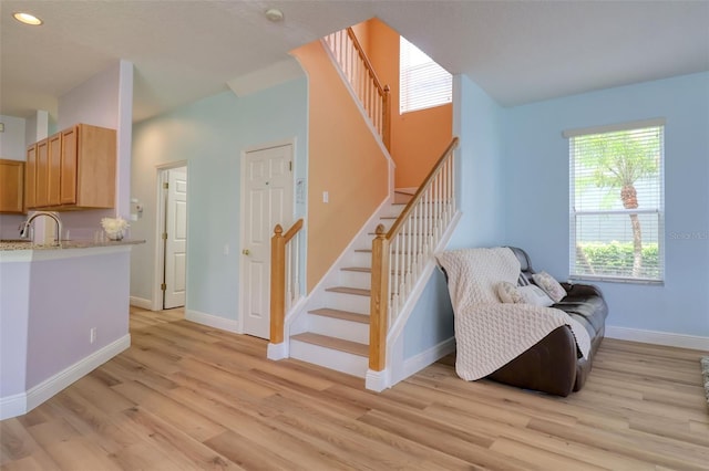 2228 Hannah Way S, Dunedin, FL 34698 - sitting room featuring stairs, light wood-style floors, and recessed lighting