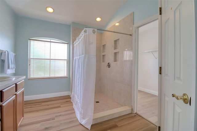 2228 Hannah Way S, Dunedin, FL 34698 - bathroom with tiled shower, wood finished floors, vanity, a closet, and recessed lighting