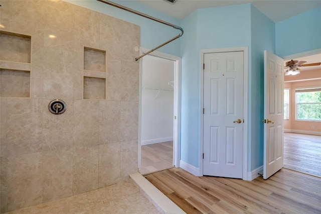 2228 Hannah Way S, Dunedin, FL 34698 - bathroom featuring a tile shower, wood finished floors, ceiling fan, and a closet