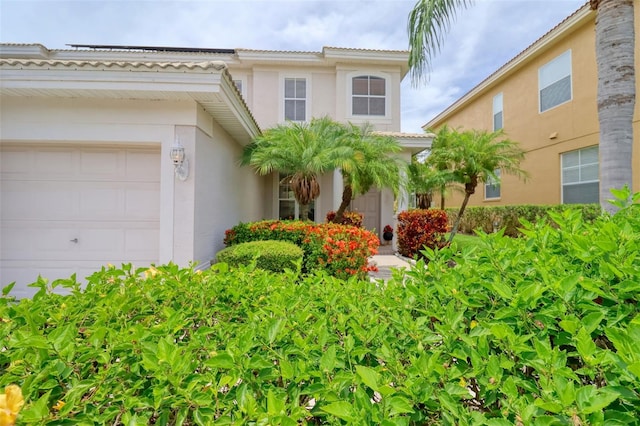 2228 Hannah Way S, Dunedin, FL 34698 - view of front facade featuring a garage, stucco siding, and a tiled roof