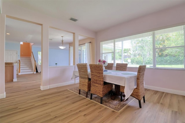 2228 Hannah Way S, Dunedin, FL 34698 - dining area with light wood finished floors and stairs