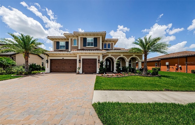 29038 Picana Ln, Wesley Chapel, FL 33543 - mediterranean / spanish home with decorative driveway, a garage, stucco siding, a front yard, and a tiled roof